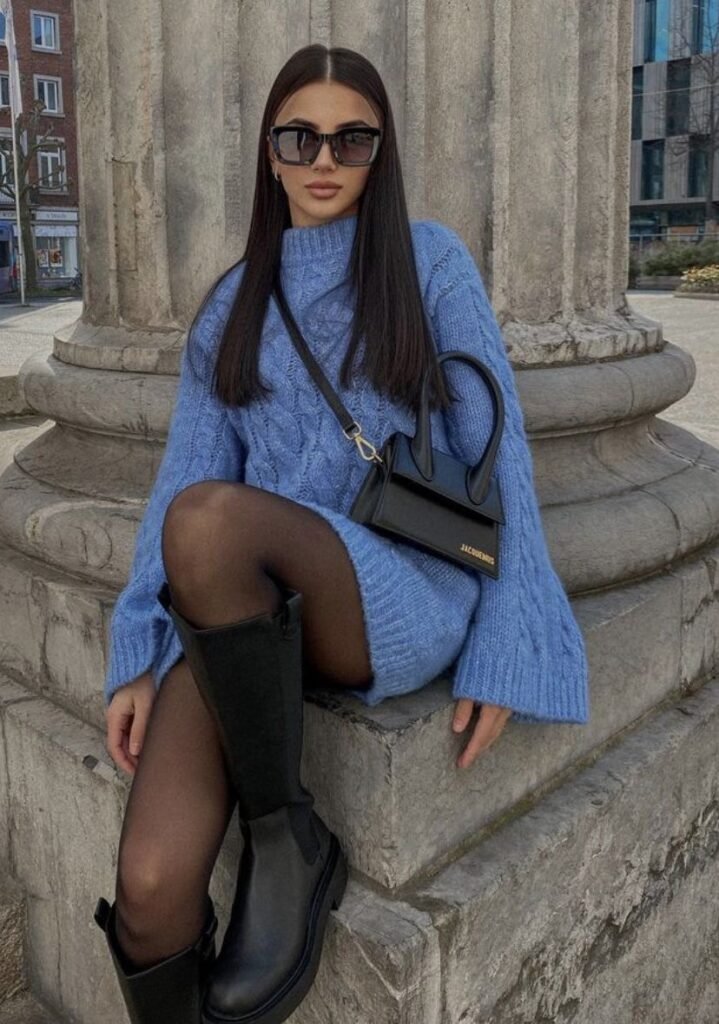 A woman wearing a blue wool dress.