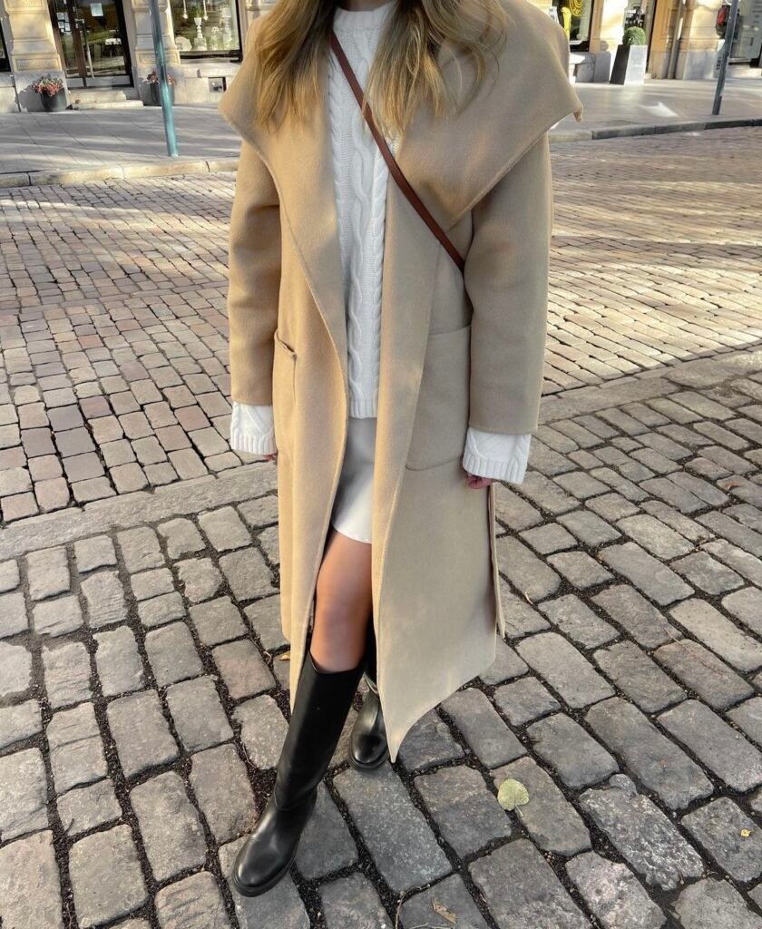 A cream wool coat with a white outfit.