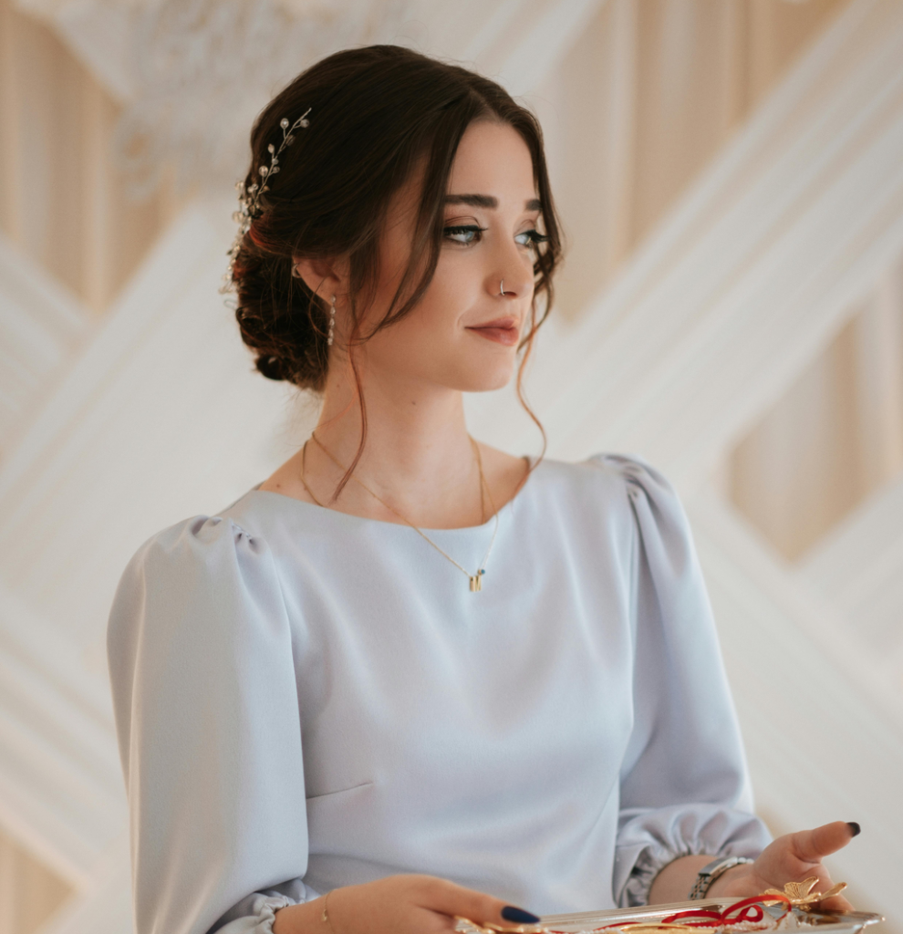 A woman wearing a pale blue dress.