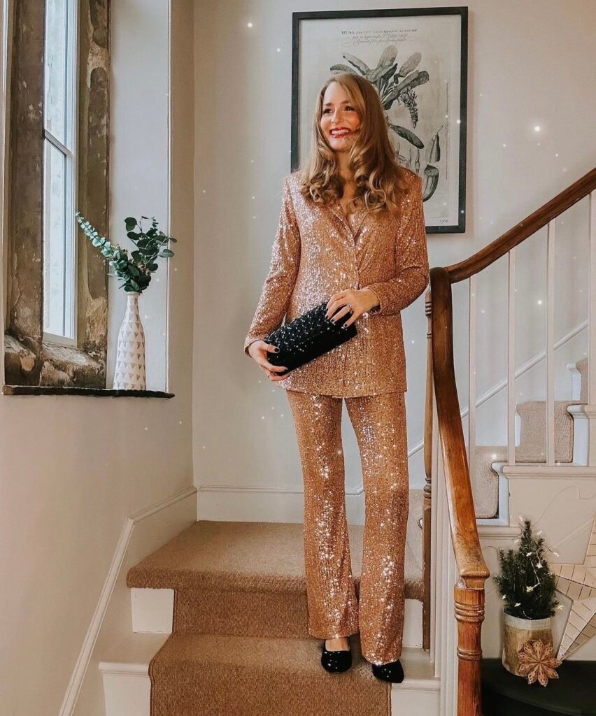 A woman wearing a gold glitter suit.