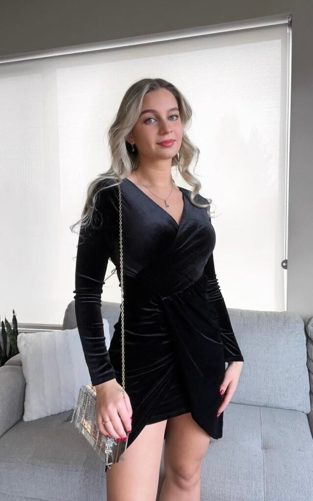 A woman wearing a black velvet dress.