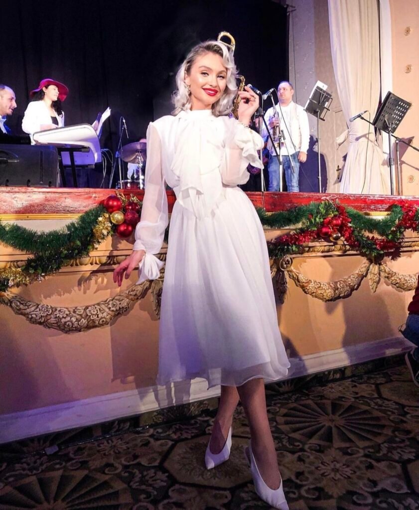 A woman wearing a white ruffle dress.