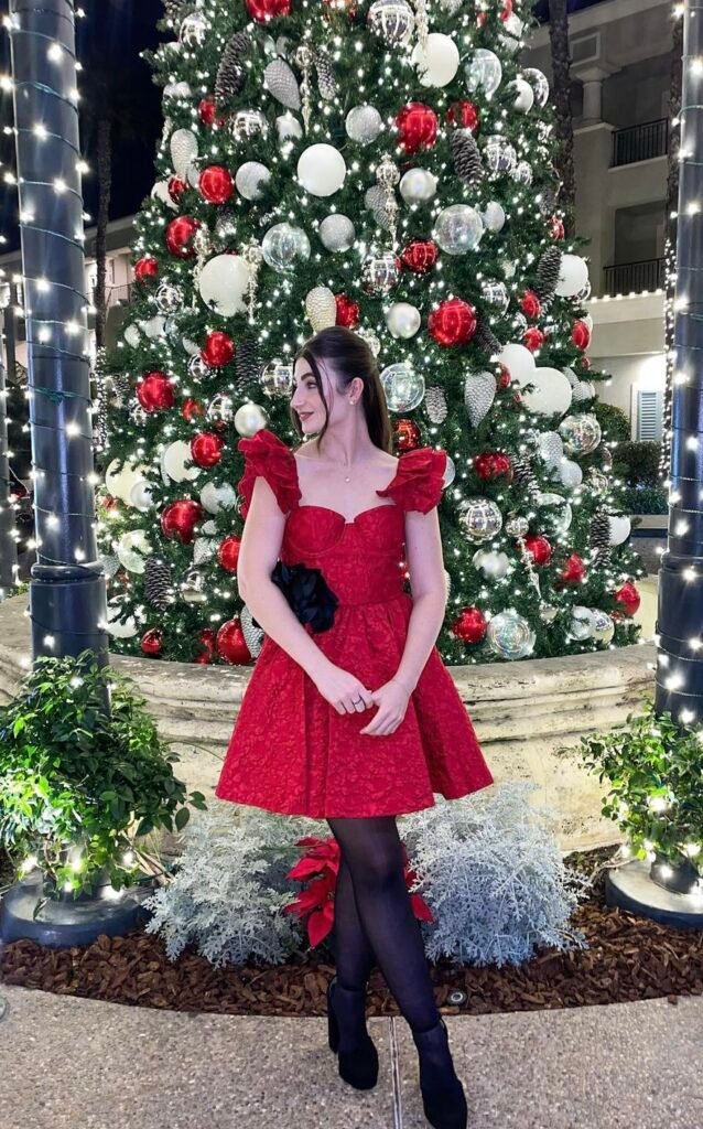 A woman wearing a red textured dress.