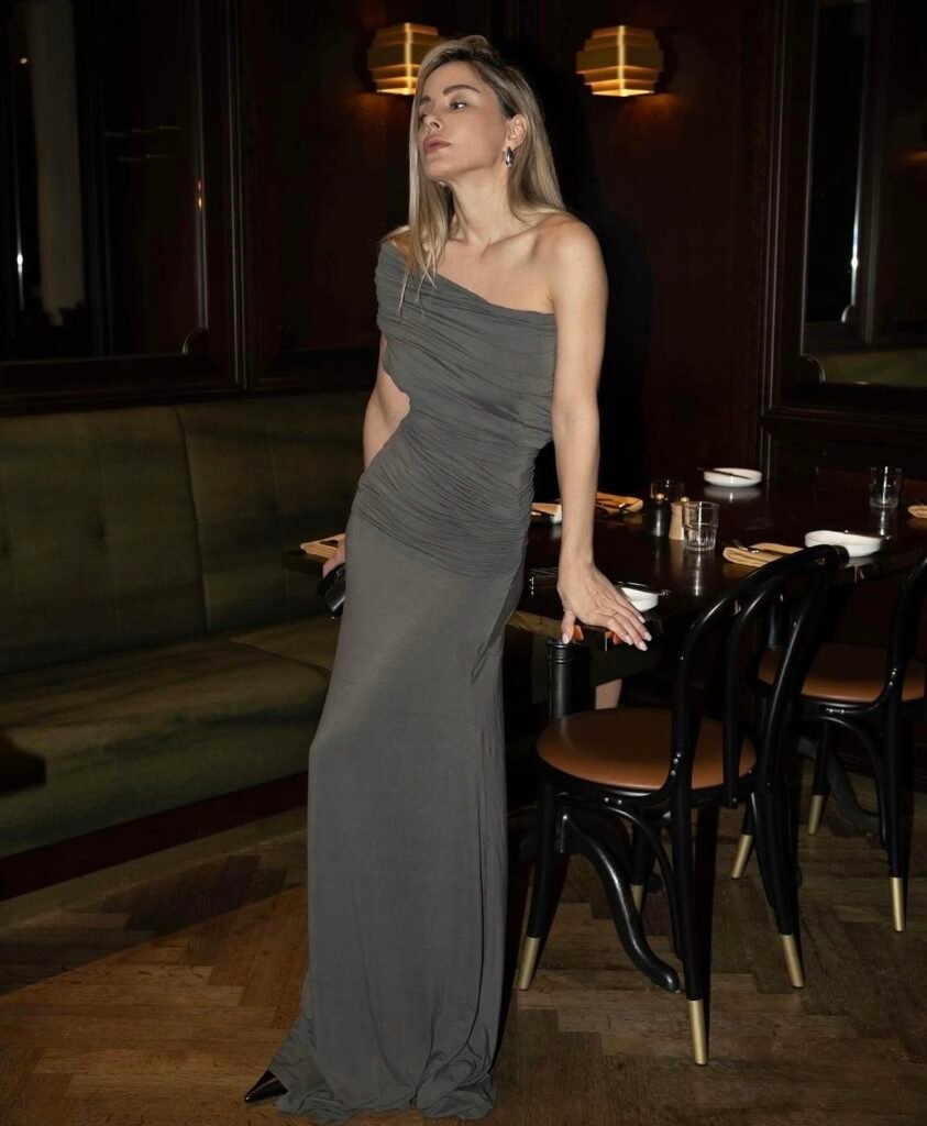 A woman wearing a long gray dress.