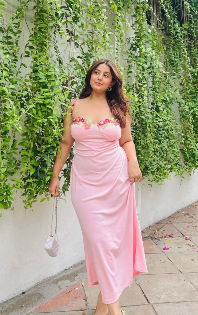 A woman wearing a pink floral dress.