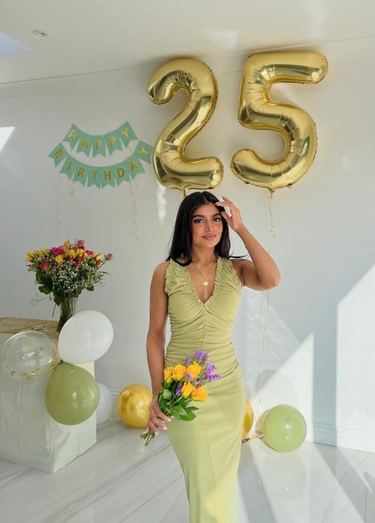 A woman wearing a long green dress.