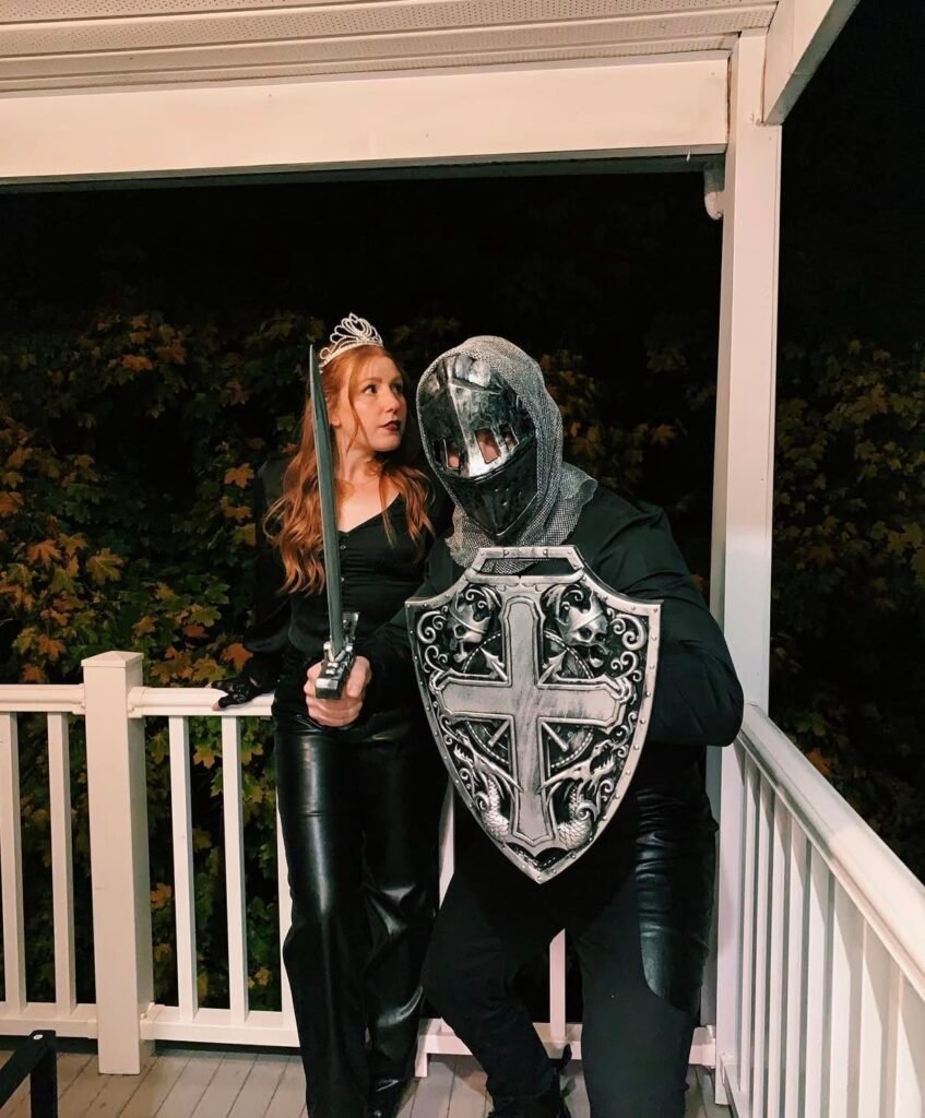 A couple wearing princess and knight Halloween costumes.