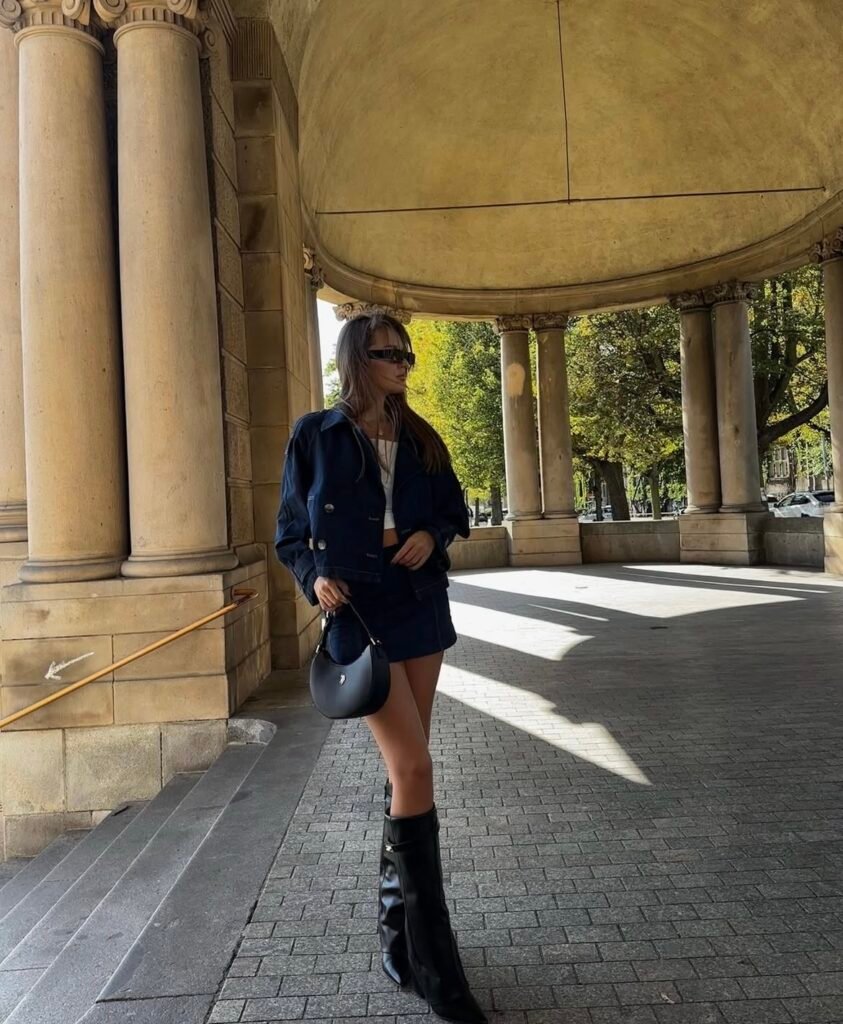 A woman wearing a denim suit.