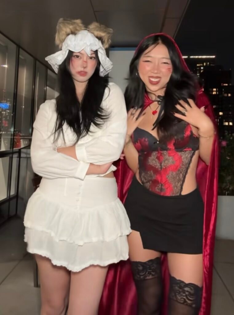 Best friends wearing Little Red Riding Hood and wolf Halloween costumes.
