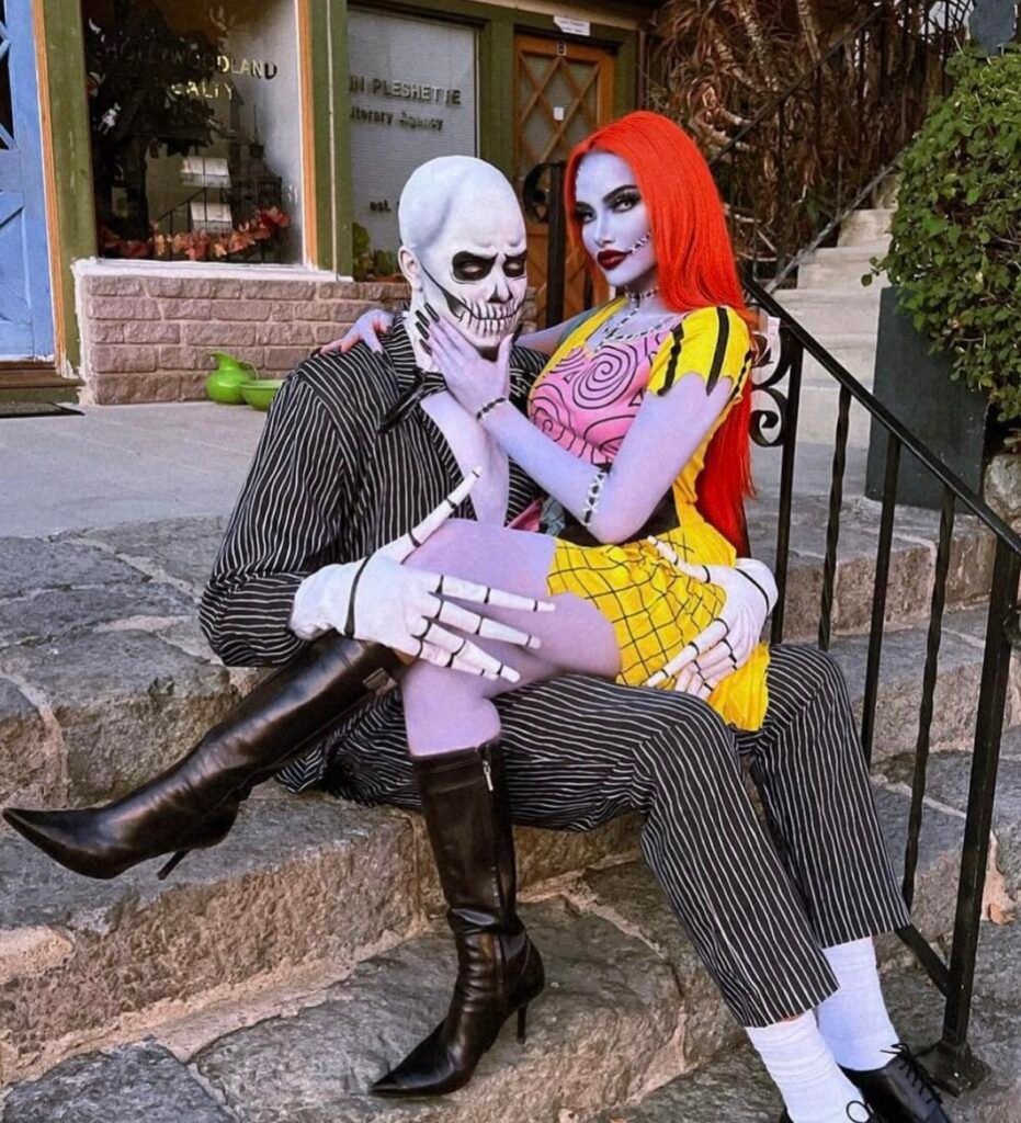 A couple wearing Jack Skellington and Sally Halloween costumes.