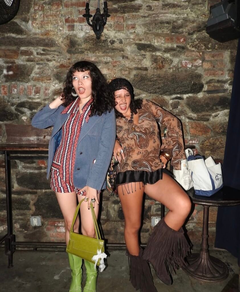 Best friends wearing 70s Halloween costumes.
