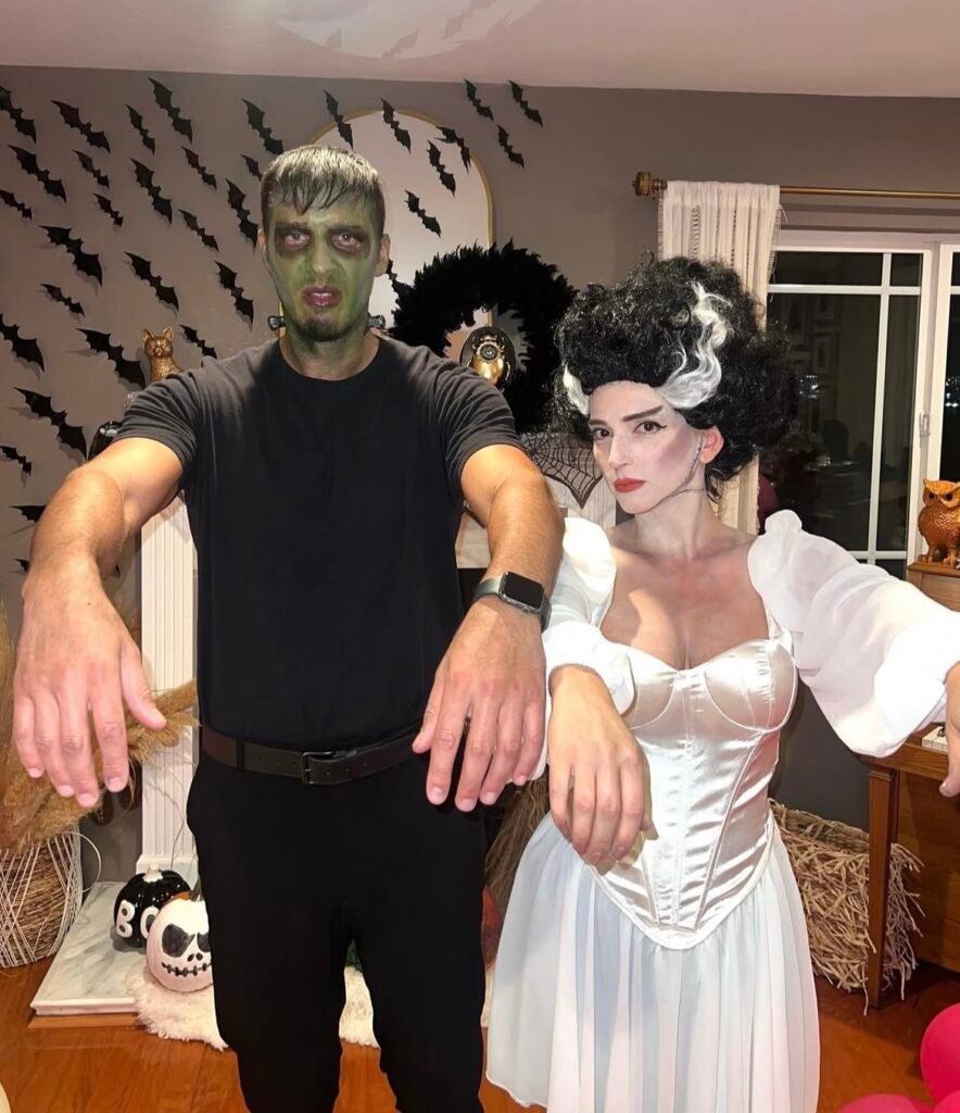 A couple wearing Frankenstein and Elizabeth Halloween costumes.