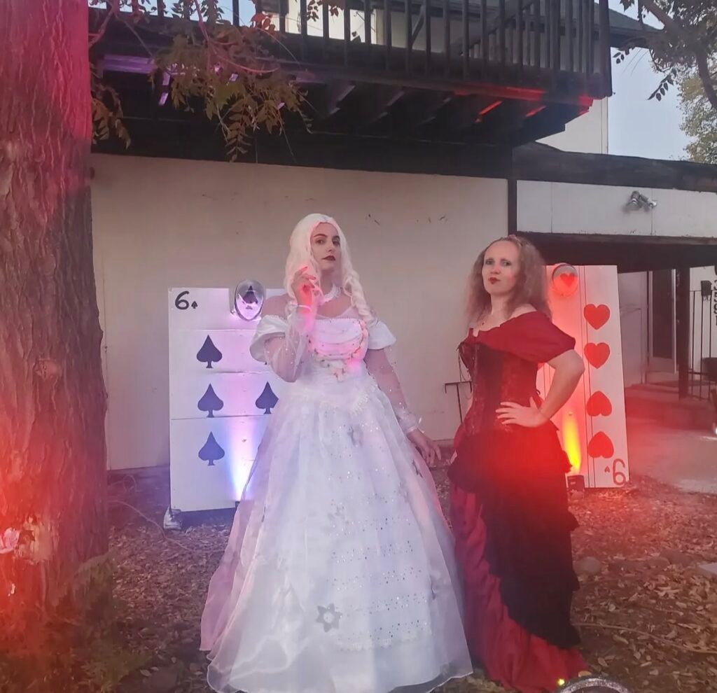 Best friends wearing Red Queen and White Queen Halloween costumes.