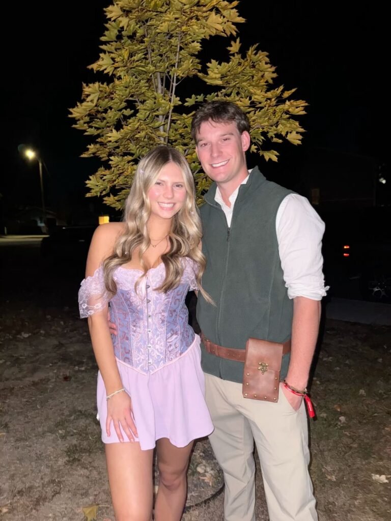 A couple wearing Rapunzel and Flynn Halloween costumes.