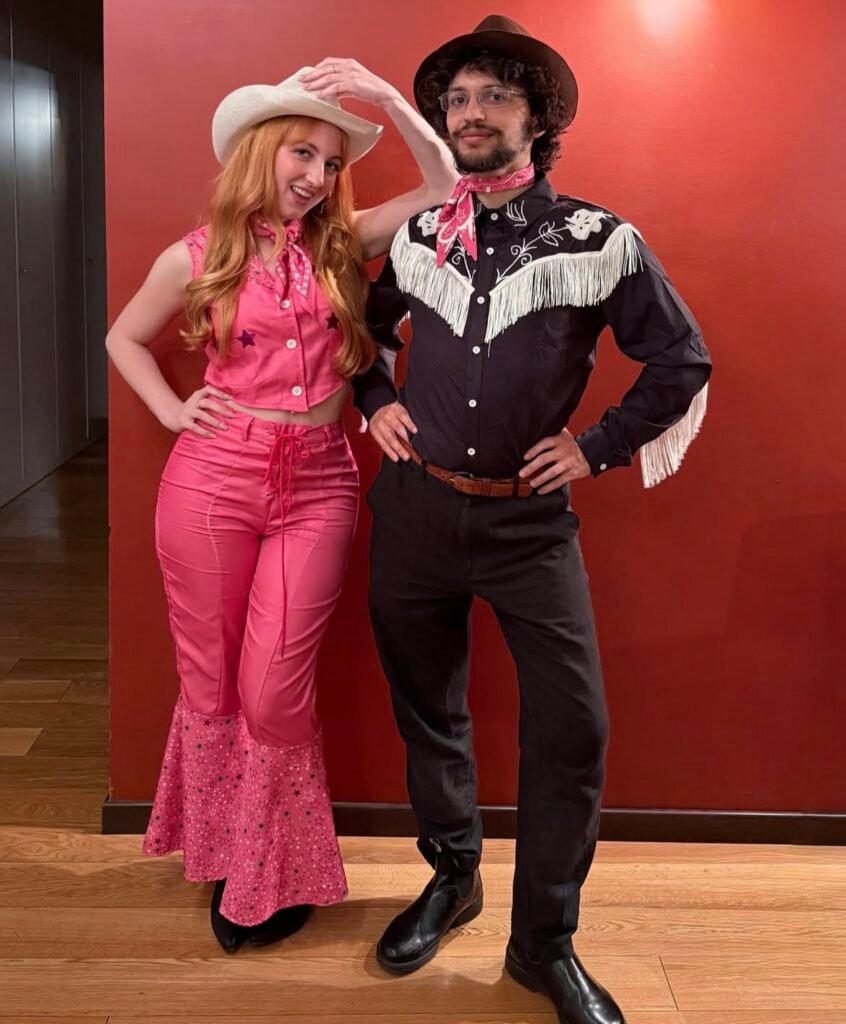 A couple wearing Barbie and Ken Halloween costumes.