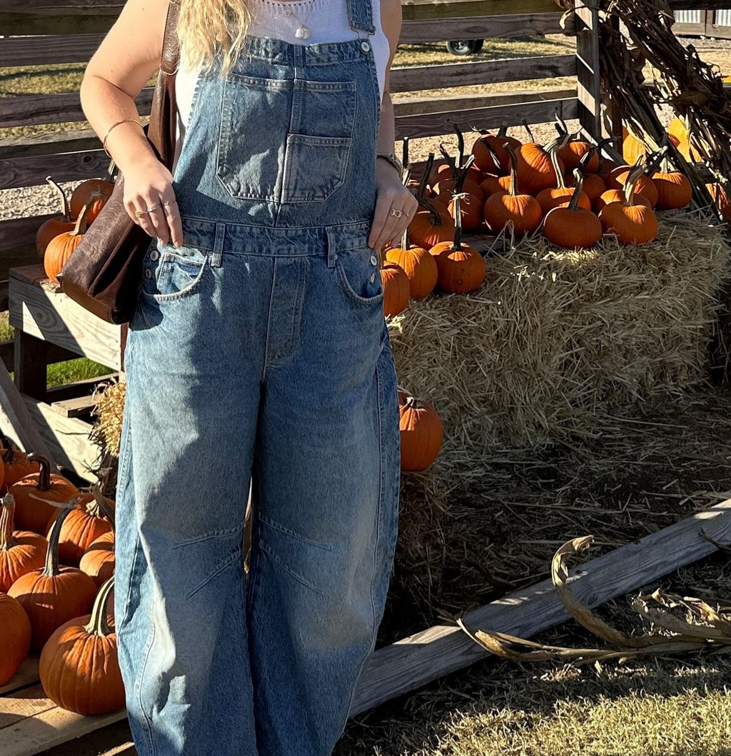 A woman wearing overalls.