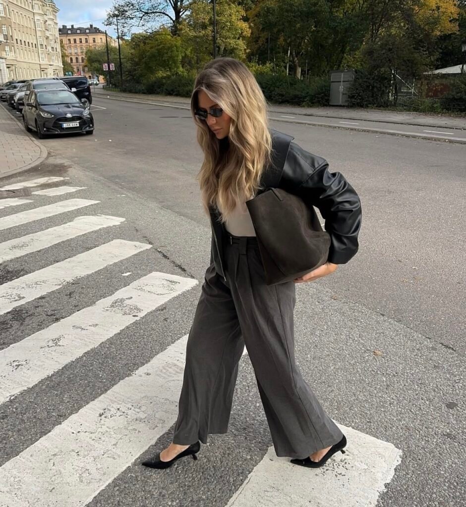 An outfit with a black faux leather jacket.
